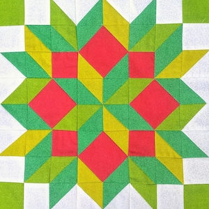 May include: A quilt block with a starburst pattern in shades of green, red, and yellow. The block is made up of squares and triangles.