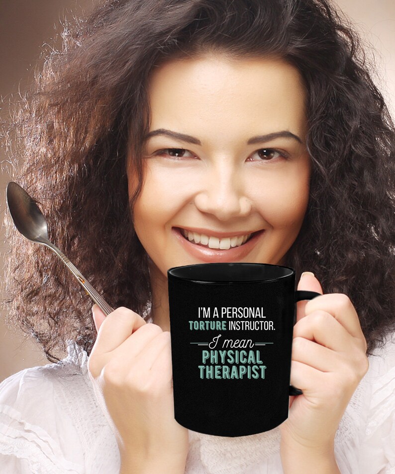 May include: Black coffee mug with white text that reads "I'm a personal torture instructor. I mean physical therapist."