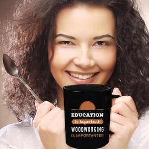 May include: Black coffee mug with a brown wood grain design and the text "EDUCATION is important WOODWORKING IS IMPORTANTER".