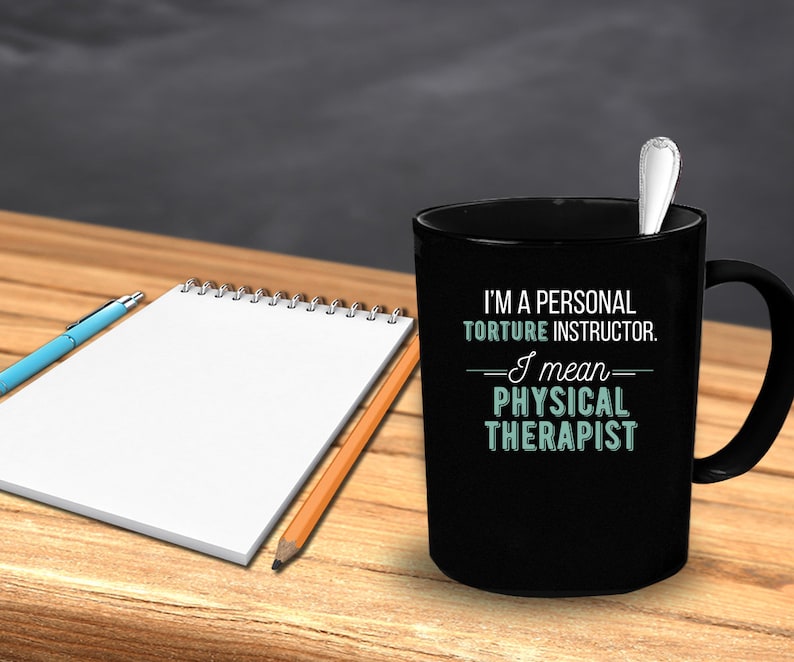 May include: Black coffee mug with white text that reads "I'm a personal torture instructor. I mean physical therapist."