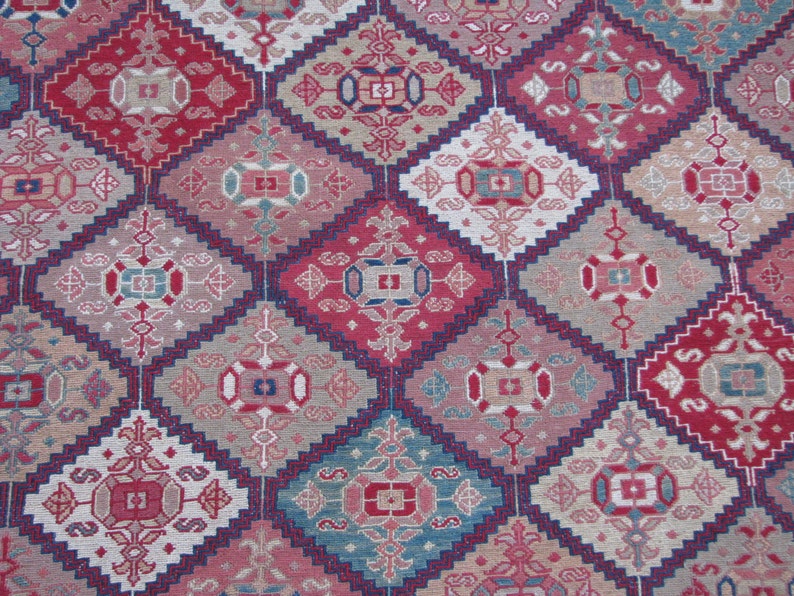 May include: A close-up of a patterned rug with a repeating diamond design. The rug features a variety of colors, including red, blue, and white.