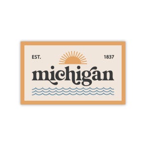 May include: A vintage-style graphic with a stylized sun and waves, featuring the text "EST. 1837 michigan" in a black sans-serif font on a beige background with a brown border.