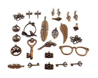 lot 25 pendentif breloque bronze clé lunette plume feuille oiseau clé de sol musique pieuvre coquillage appareil