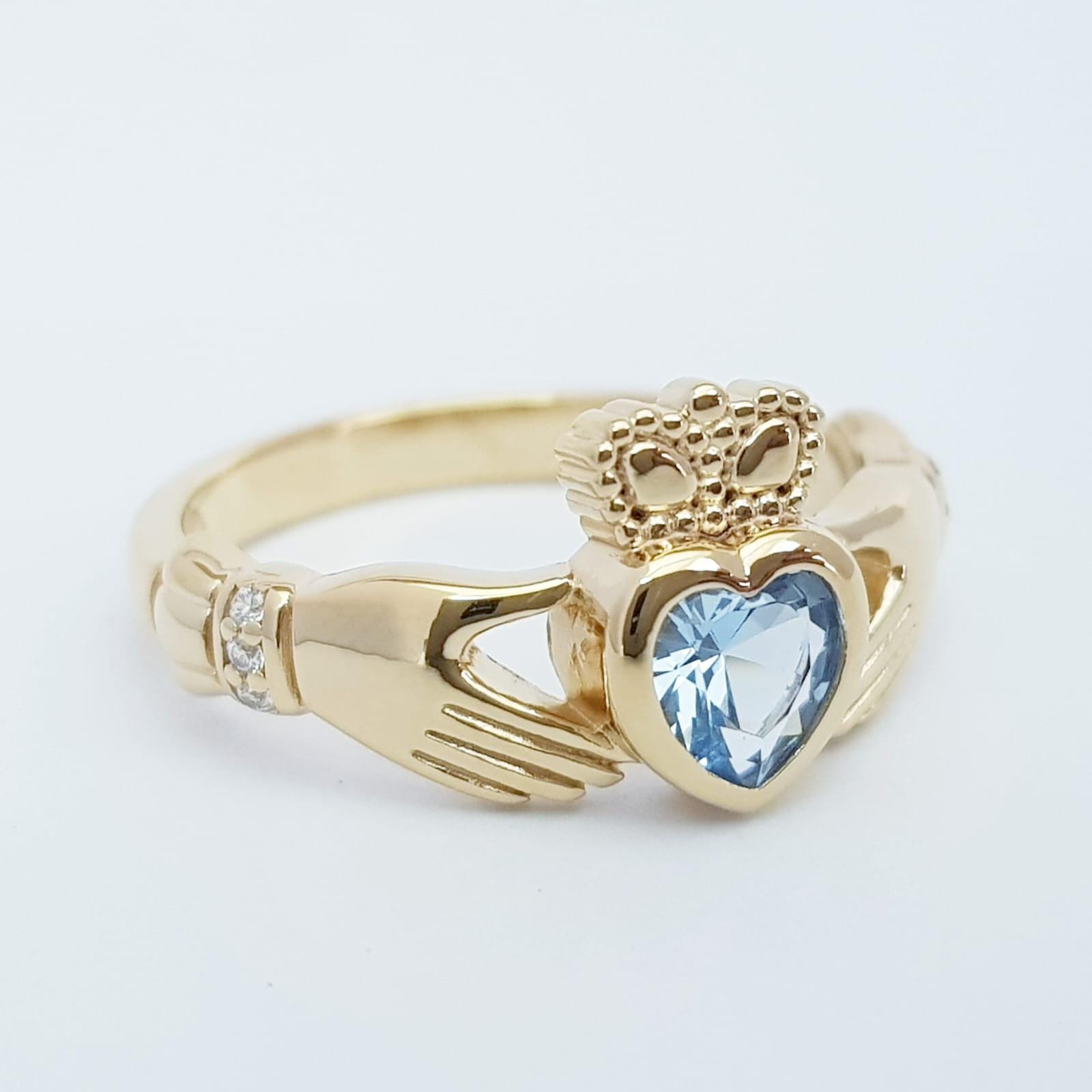 Sterling Silver Yellow Gold plated Claddagh ring set with aquamarine heart shaped stone, may birthstone claddagh ring from Ireland