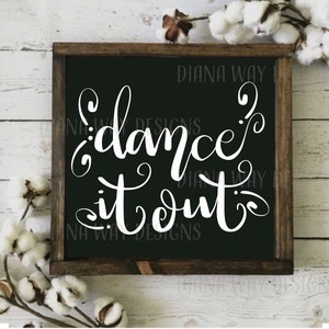 May include: A black framed sign with white text that reads "dance it out". The sign is on a white wood background with cotton bolls.