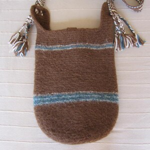 May include: A brown knitted bag with blue and white stripes and fringe details. The bag has a long strap and is made of a soft, textured material.