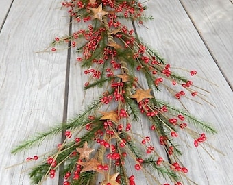 May include: A long, rustic Christmas garland with red berries and gold stars. The garland is made of natural materials and is perfect for adding a touch of farmhouse charm to your holiday decor.