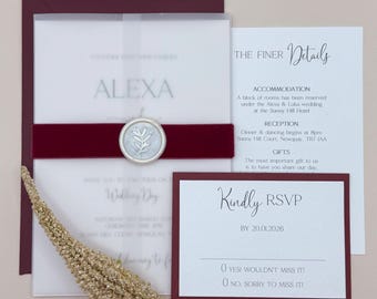 May include: Wedding invitation with a burgundy and white color scheme. The invitation features a wax seal with a leaf design and the text "Alexa" in a modern font. The invitation also includes details about the wedding reception, accommodation, and RSVP information.