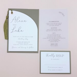May include: A green and white wedding invitation with a gold tassel. The invitation reads "Alexa and Luka Invite you to join them on their Wedding Day Saturday 21st March 2006 Ceremony Time 4PM Sunny Hill Court, Newquay, TR7 1AA Dinner and dancing to follow"