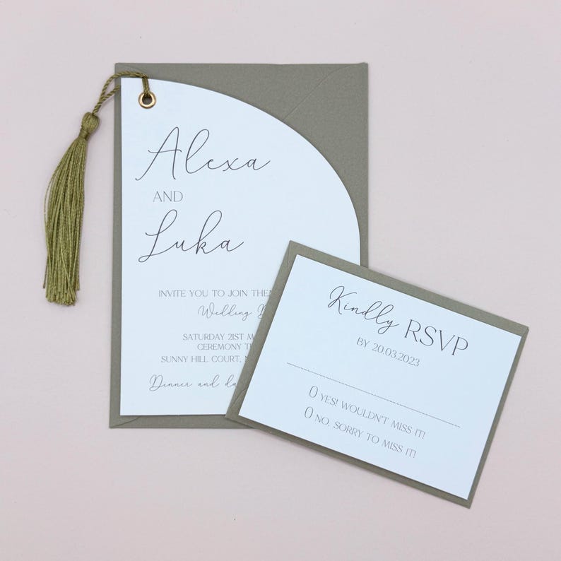 May include: A sage green wedding invitation with a white RSVP card. The invitation features a half-circle design with the names "Alexa and Luka" in cursive script. The RSVP card has the text "Kindly RSVP by 20.03.2023" and two options: "Yes, I wouldn't miss it!" and "No, sorry to miss it!"