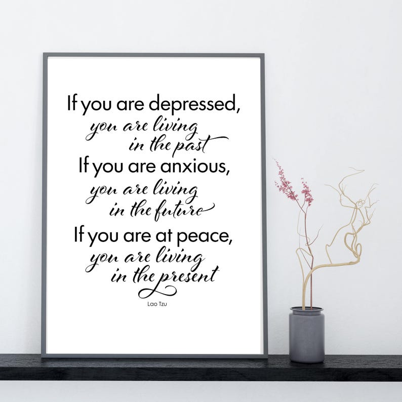 May include: A framed print with a white background features a quote by Lao Tzu: "If you are depressed, you are living in the past. If you are anxious, you are living in the future. If you are at peace, you are living in the present."