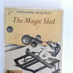 May include: Vintage book cover for "The Magic Sled" by Nathaniel Benchley. The cover features a black and white illustration of a sled, figures, and floating orbs. The book is published by Harper Crest.