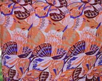 May include: A pink and orange fabric with a repeating pattern of butterflies. The butterflies are in shades of purple, brown, and white.