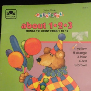 May include: A colorful book cover with a cartoon bear wearing a clown hat and holding balloons. The book title is "about 1-2-3" and the subtitle is "THINGS TO COUNT FROM 1 TO 10".