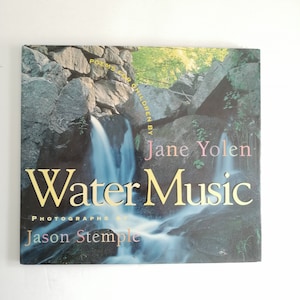 May include: A book titled "Water Music" by Jane Yolen, with photographs by Jason Stemple. The cover features a waterfall scene with the title in gold lettering. The book is a collection of poems for children.