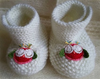Hand knitted white merino wool baby booties decorated with crocheted owl