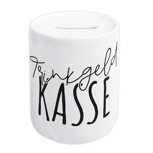 Op de afbeelding: Witte keramische spaarpot met een zwarte inscriptie die "Trinkgeld Kasse" luidt.