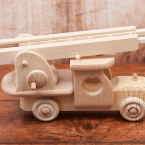 May include: A wooden toy fire truck with a ladder that extends up and down. The truck is made of natural wood and has a simple, classic design.