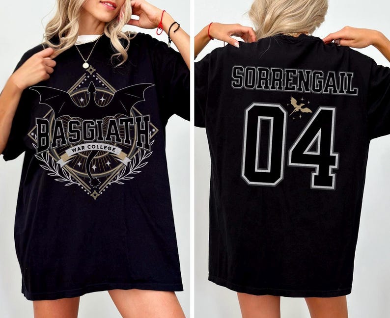 Black oversized t-shirt inspired by Fourth Wing featuring a bold ‘Basgiath War College’ crest on the front with swords, wings, stars, and laurel branches. The back showcases the name ‘Sorrengail’ above the number ‘04’ in a varsity-style font, with a small dragon graphic above the numbers. Modeled by a blonde woman, showing both front and back views. Perfect for fans of the Riders Quadrant and fantasy academy themes