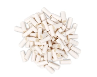 May include: A large pile of white chew sticks for dogs. The sticks are cylindrical and have a slightly rough texture.