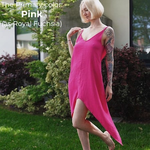 A woman in a pink dress stands in a grassy area, with a house and trees in the background.