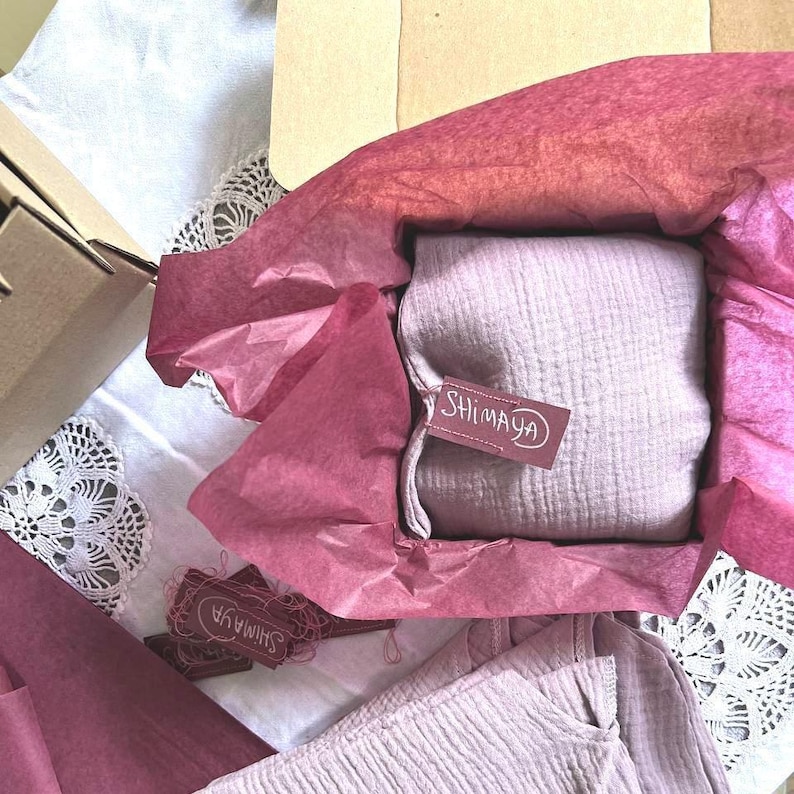 a box with a pink cloth inside of it