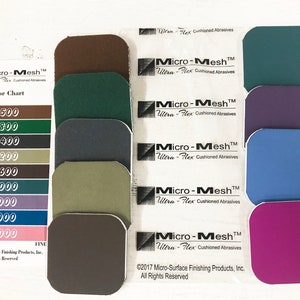 May include: Color chart for Micro-Mesh Ultra-Flex Cushioned Abrasives. The chart shows 10 different colors of sandpaper, ranging from coarse to fine. The grit numbers are listed on the left side of the chart, and the corresponding color squares are on the right.