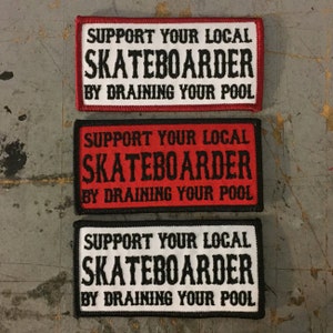 May include: Three embroidered patches with black text on a white background and red or black borders. The text reads "Support your local skateboarder by draining your pool."