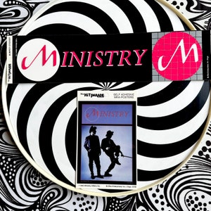 May include: A collection of vintage "Ministry" band merchandise, including a bumper sticker, a mini-poster, and a circular sticker. The bumper sticker is black with pink text and a white circle. The mini-poster features two silhouetted figures.