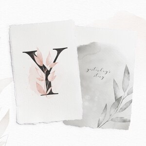 May include: A watercolor illustration of the letter Y with pink and gray leaves. The text "yesterday's story" is written in cursive on a separate piece of paper.