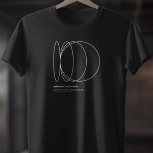 May include: Black t-shirt featuring a white graphic design of overlapping circles and the text "subsonic audioworks".