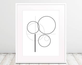 May include: Black and white geometric abstract art print with overlapping circles and lines. The print is framed in a white frame.