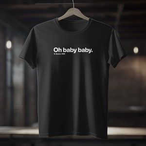 Peut inclure: T-shirt noir avec un texte blanc qui dit "Oh baby baby." et "B. Spears, 1998".
