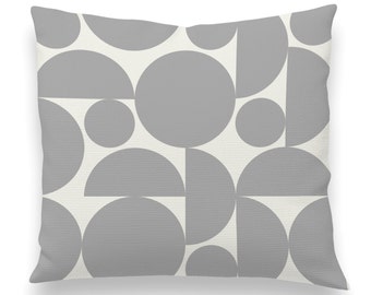 May include: A gray and white geometric pillow with a pattern of circles and semi-circles.
