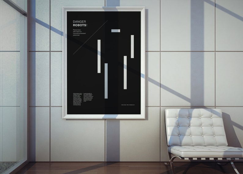 May include: A black and white poster with the text "DANGER ROBOTS!" and a stylized robot figure made of white lines. The poster is framed in white and hanging on a white tiled wall.