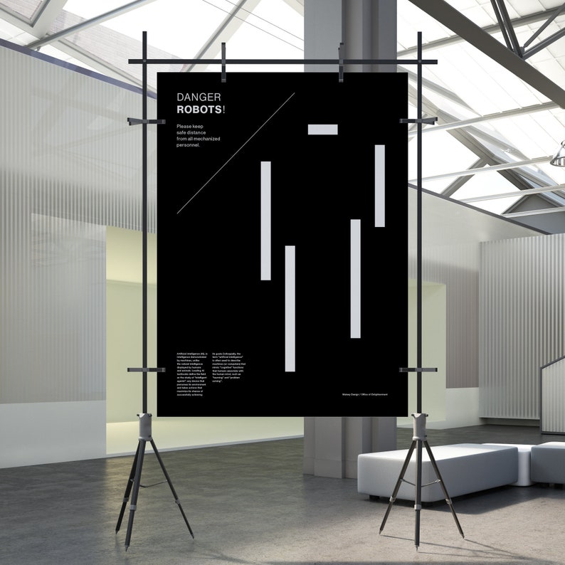 May include: A black and white poster with the text "DANGER ROBOTS!" and a warning to keep a safe distance from all mechanized personnel. The poster is displayed on a tripod in a modern, minimalist setting.
