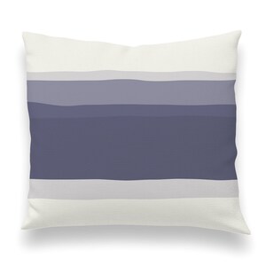 May include: A white throw pillow with a horizontal stripe pattern in shades of gray and blue.