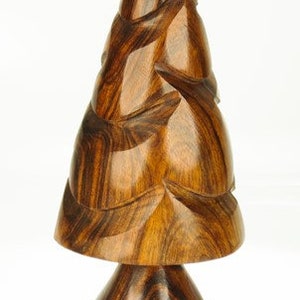 May include: A wooden Christmas tree ornament carved in a stylized design with a brown and gold finish.