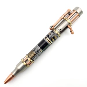 Könnte beinhalten: Ein schwarzer und kupferfarbener Stift im Steampunk-Design. Der Stift ist aus einer Gewehrkugel gefertigt und hat ein Leiterplattenmuster auf dem Schaft. Der Stift hat einen Mechanismus aus Kupfer und Silber mit einem Hebel an der Seite.