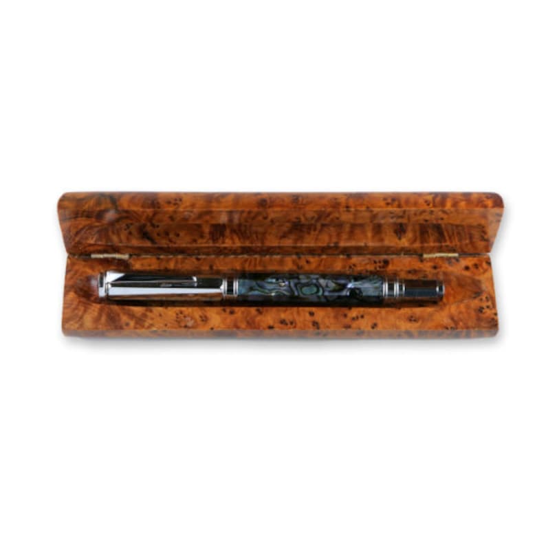 May include: A silver and blue pen with a marbled design is in a wooden box with a burl wood finish.