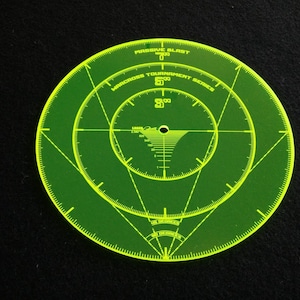 May include: A green lacrosse shooting target with concentric circles and a centre point. The target is labelled "Massive Blast Lacrosse Tournament Series".