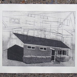 May include: Black and white architectural print depicting a building with a dark roof and multiple windows. The print has a minimalist style with geometric lines overlaying the building's structure. The artwork is on a white paper with a rough edge.