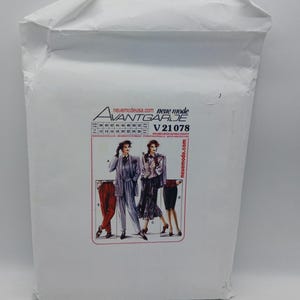 May include: A white envelope with a sewing pattern on the front. The pattern is for a women's clothing design and features three different outfits. The pattern is called "Avantgarde" and the pattern number is "V 21078". The website "neue mode" is printed on the envelope.