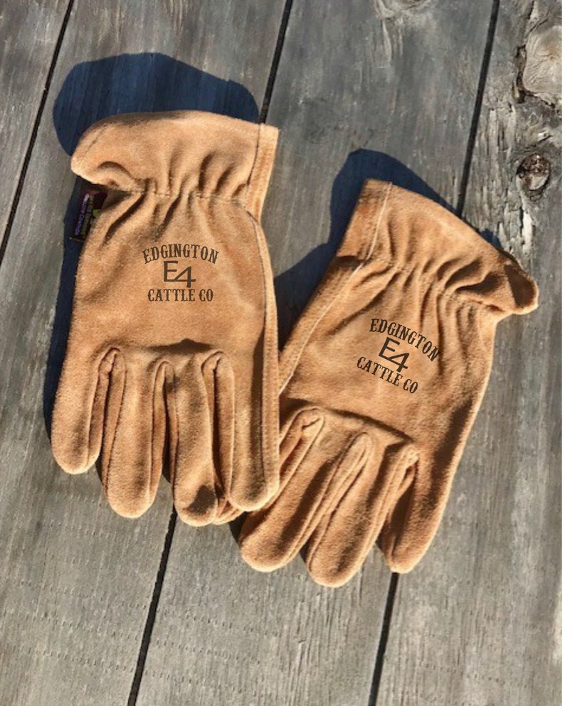 May include: A pair of brown leather work gloves with the text "Edgington E4 Cattle Co" on the back of each glove.