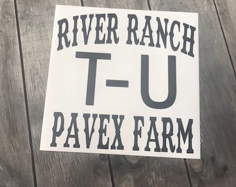 May include: White sign with black text that reads "River Ranch T-U Pavex Farm".