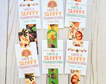 May include: A collection of Thanksgiving-themed bookmarks. Each bookmark features a decorative top with fall motifs like pumpkins, turkeys, and leaves. The bookmarks have a white card with the text "HAVE A SLAPPY THANKSGIVING!" and a personalized message.