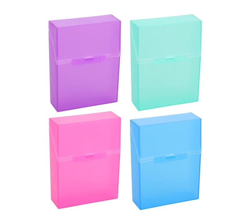 May include: Four brightly coloured plastic cigarette cases in purple, teal, pink, and blue. Each case has a hinged lid and a rectangular shape. The cases are made of translucent plastic.