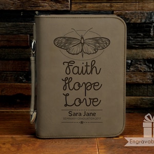 May include: A brown leather journal with a butterfly design and the words "Faith Hope Love" engraved on the front. The journal also has the name "Sara Jane" and the text "Seminary Graduation 2017" engraved on the front.