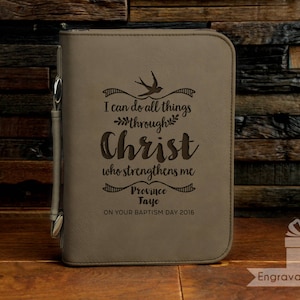 May include: A brown leather-bound journal with a personalized inscription. The inscription reads "I can do all things through Christ who strengthens me Province Faye ON YOUR BAPTISM DAY 2016".