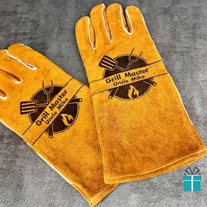 May include: A pair of yellow grilling gloves with white stitching. Each glove features a circular emblem with a spatula, fork, and flame, and the text "Grill Master Uncle Mike".